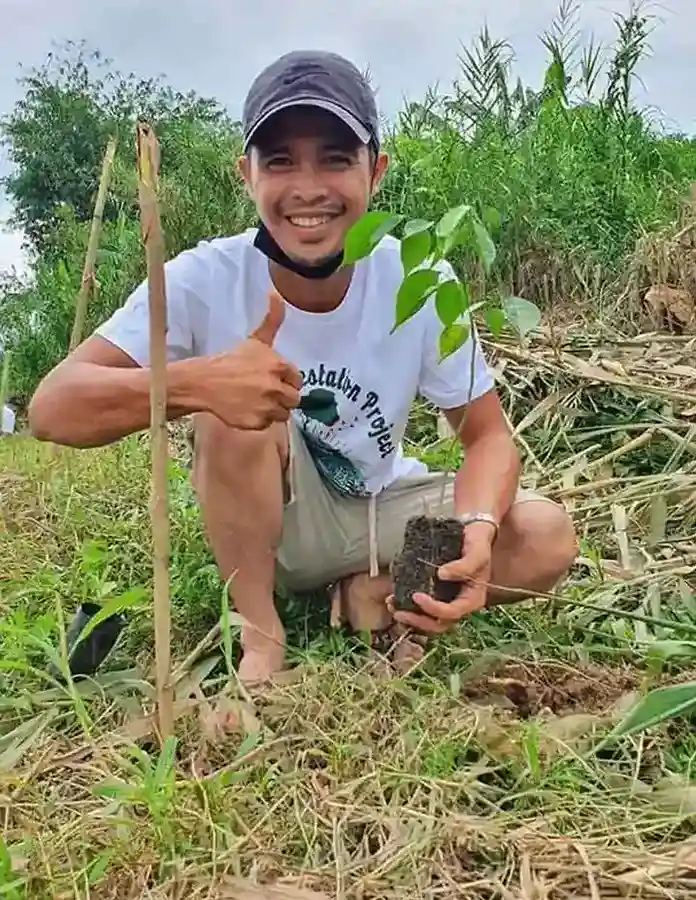 Philippines man planting tree
