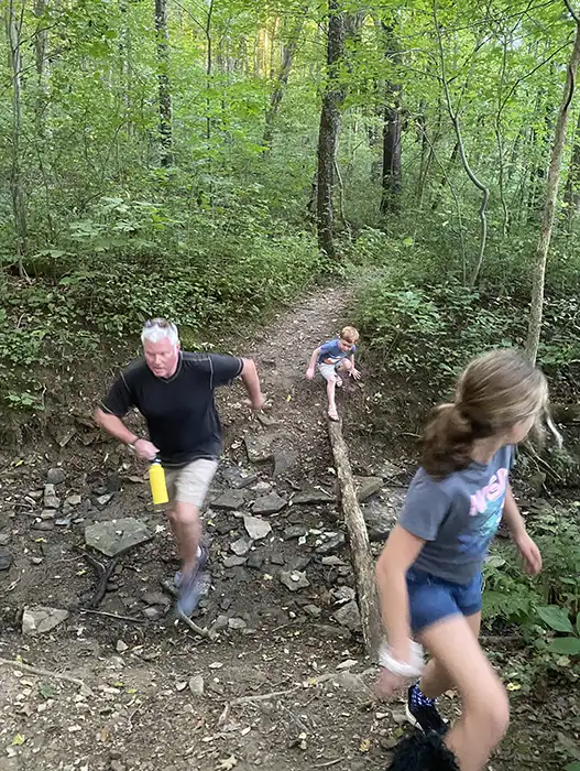 earth-day-planting-2022 Jumping across creek