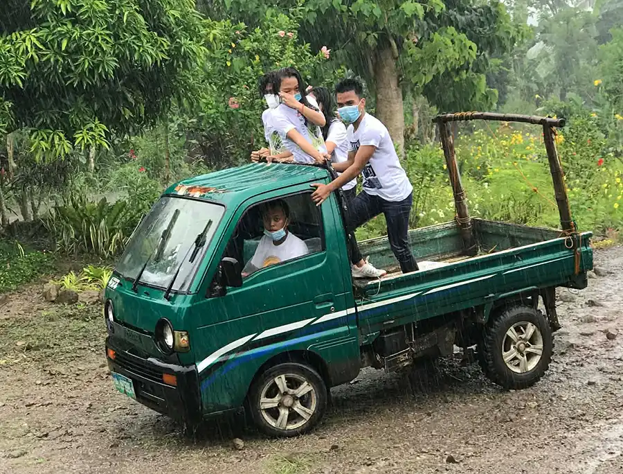 Four people on small loading truck in Philippines