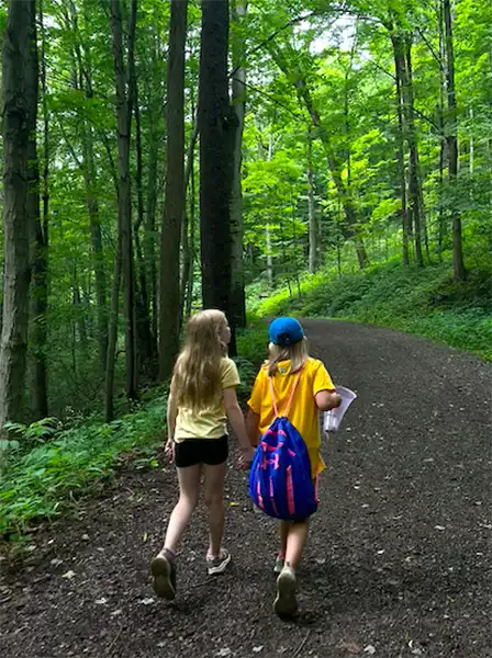 2 girls walking in forest